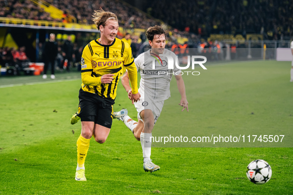 Julian Brandt of Borussia Dortmund and William Boving of SK Sturm Graz play during the UEFA Champions League 2024/25 League Phase MD4 soccer...