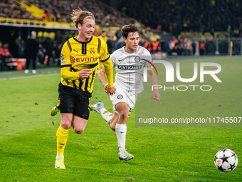 Julian Brandt of Borussia Dortmund and William Boving of SK Sturm Graz play during the UEFA Champions League 2024/25 League Phase MD4 soccer...