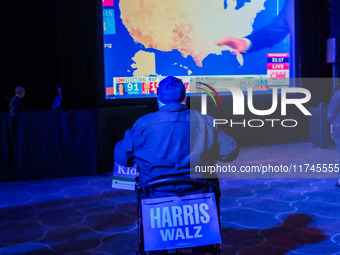 Attendees watch television coverage of the United States 2024 election at the Minnesota DFL Election Night event at the InterContinental Hot...