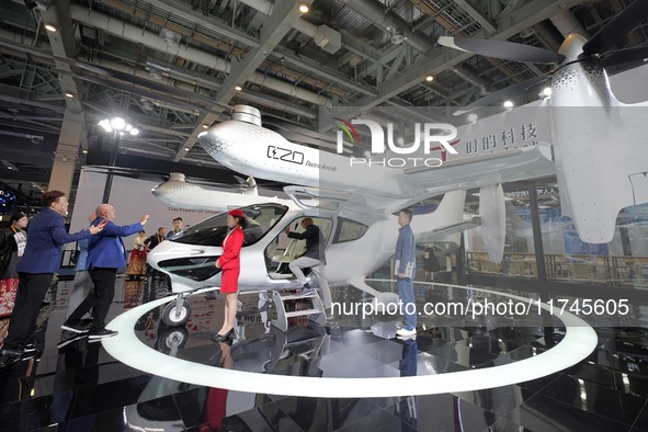 Visitors learn about the technology E20 eVTOL electric vertical take-off and landing vehicle at the 7th CIIE in Shanghai, China, on November...