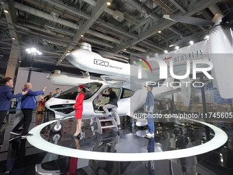 Visitors learn about the technology E20 eVTOL electric vertical take-off and landing vehicle at the 7th CIIE in Shanghai, China, on November...