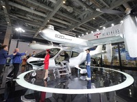 Visitors learn about the technology E20 eVTOL electric vertical take-off and landing vehicle at the 7th CIIE in Shanghai, China, on November...