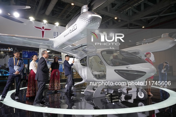 Visitors learn about the technology E20 eVTOL electric vertical take-off and landing vehicle at the 7th CIIE in Shanghai, China, on November...