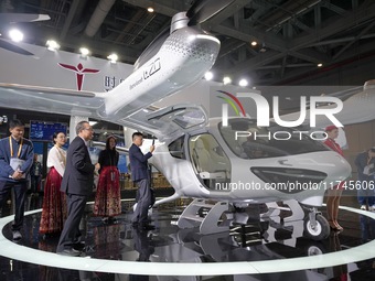 Visitors learn about the technology E20 eVTOL electric vertical take-off and landing vehicle at the 7th CIIE in Shanghai, China, on November...