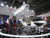 Visitors learn about the technology E20 eVTOL electric vertical take-off and landing vehicle at the 7th CIIE in Shanghai, China, on November...