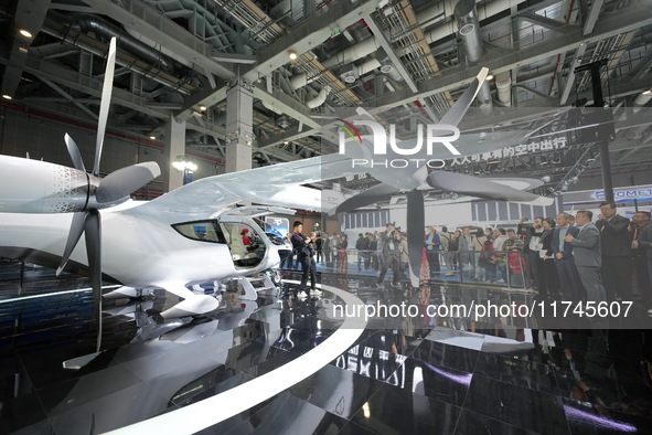 Visitors learn about the technology E20 eVTOL electric vertical take-off and landing vehicle at the 7th CIIE in Shanghai, China, on November...