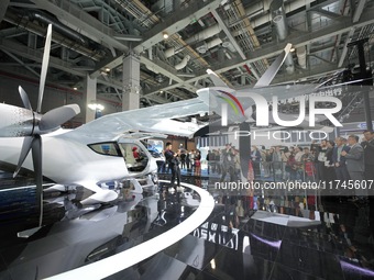 Visitors learn about the technology E20 eVTOL electric vertical take-off and landing vehicle at the 7th CIIE in Shanghai, China, on November...