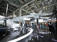 Visitors learn about the technology E20 eVTOL electric vertical take-off and landing vehicle at the 7th CIIE in Shanghai, China, on November...