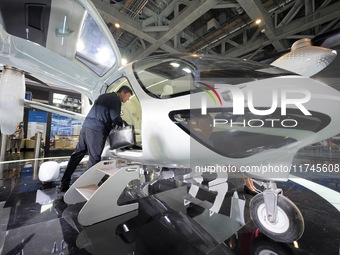 Visitors learn about the technology E20 eVTOL electric vertical take-off and landing vehicle at the 7th CIIE in Shanghai, China, on November...