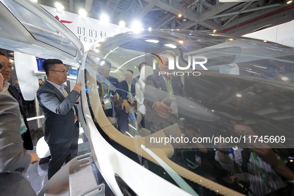 Visitors learn about the technology E20 eVTOL electric vertical take-off and landing vehicle at the 7th CIIE in Shanghai, China, on November...