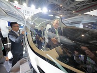 Visitors learn about the technology E20 eVTOL electric vertical take-off and landing vehicle at the 7th CIIE in Shanghai, China, on November...