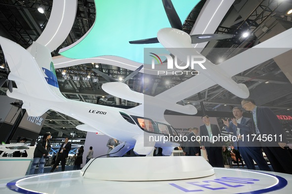 Visitors learn about the LE200 electric vertical take-off and landing passenger aircraft of Yi Airlines at the 7th CIIE in Shanghai, China,...