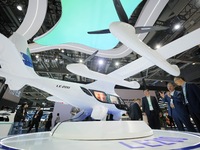 Visitors learn about the LE200 electric vertical take-off and landing passenger aircraft of Yi Airlines at the 7th CIIE in Shanghai, China,...