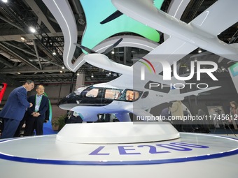 Visitors learn about the LE200 electric vertical take-off and landing passenger aircraft of Yi Airlines at the 7th CIIE in Shanghai, China,...