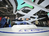 Visitors learn about the LE200 electric vertical take-off and landing passenger aircraft of Yi Airlines at the 7th CIIE in Shanghai, China,...