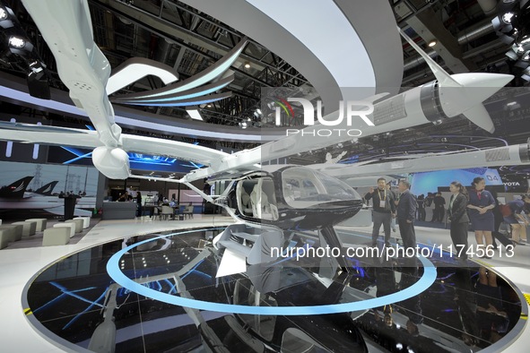 Visitors learn about the Yufeng Future MATRIX 1 electric vertical take-off and landing (VTOL) aircraft at the 7th CIIE in Shanghai, China, o...