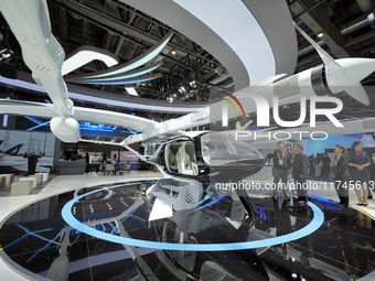 Visitors learn about the Yufeng Future MATRIX 1 electric vertical take-off and landing (VTOL) aircraft at the 7th CIIE in Shanghai, China, o...