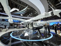 Visitors learn about the Yufeng Future MATRIX 1 electric vertical take-off and landing (VTOL) aircraft at the 7th CIIE in Shanghai, China, o...