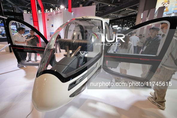 Visitors experience the VE25 Quanzhen 1:1 cabin of Volante Air at the 7th CIIE in Shanghai, China, on November 6, 2024. The Expo opens a spe...