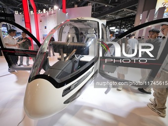 Visitors experience the VE25 Quanzhen 1:1 cabin of Volante Air at the 7th CIIE in Shanghai, China, on November 6, 2024. The Expo opens a spe...