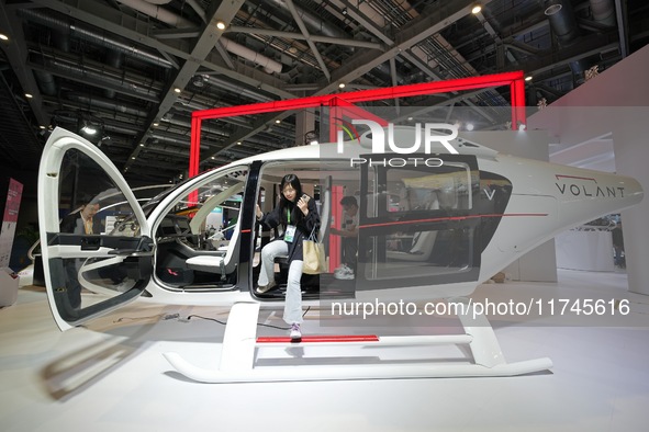 Visitors experience the VE25 Quanzhen 1:1 cabin of Volante Air at the 7th CIIE in Shanghai, China, on November 6, 2024. The Expo opens a spe...