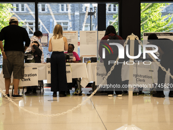 Voters stand in line at a local polling station in Washington, DC, on November 5, 2024. (