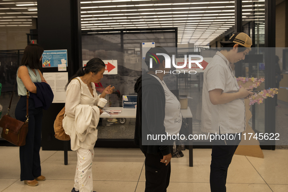 Voters stand in line at a local polling station in Washington, DC, on November 5, 2024. 