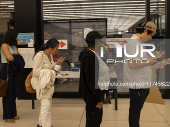 Voters stand in line at a local polling station in Washington, DC, on November 5, 2024. (