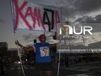 A person holds a sign during an election night event with US Vice President Kamala Harris at Howard University in Washington, DC, US, on Nov...