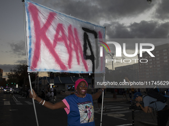 A person holds a sign during an election night event with US Vice President Kamala Harris at Howard University in Washington, DC, US, on Nov...