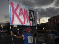 A person holds a sign during an election night event with US Vice President Kamala Harris at Howard University in Washington, DC, US, on Nov...