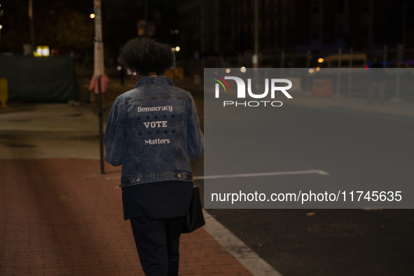 A person wears a shirt with the text ''Democracy Vote Matters'' during an election night event with US Vice President Kamala Harris at Howar...