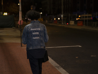 A person wears a shirt with the text ''Democracy Vote Matters'' during an election night event with US Vice President Kamala Harris at Howar...