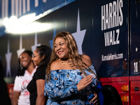 People take selfies with the Harris Walz campaign bus during a watch party for presidential election results featuring Vice President Kamala...