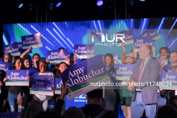 A spectator holds a sign while United States Senator Amy Klobuchar (D-MN) speaks at the Minnesota DFL Election Night event at the InterConti...