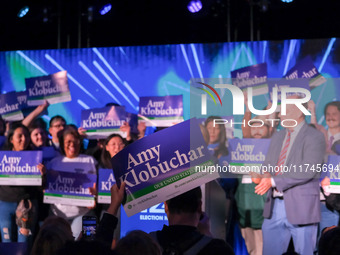 A spectator holds a sign while United States Senator Amy Klobuchar (D-MN) speaks at the Minnesota DFL Election Night event at the InterConti...