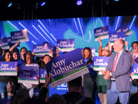 A spectator holds a sign while United States Senator Amy Klobuchar (D-MN) speaks at the Minnesota DFL Election Night event at the InterConti...