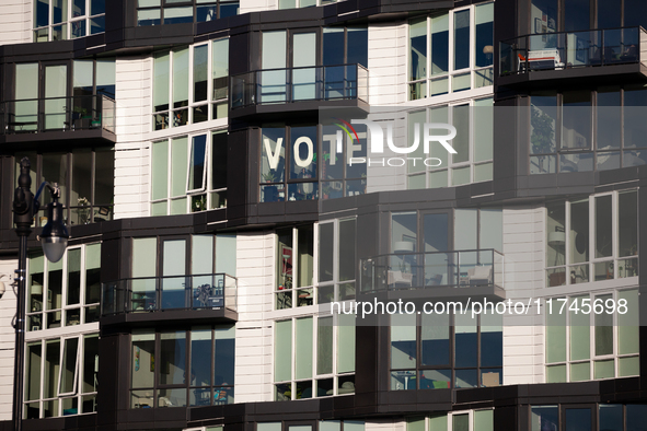 A sign in an apartment window near Howard University calls on Americans to vote, Washington, DC, on November 5, 2024.  Voters are choosing t...