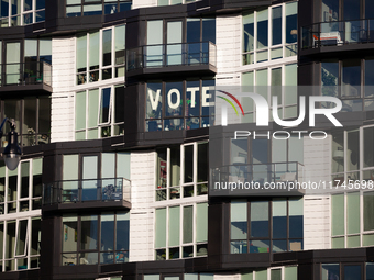 A sign in an apartment window near Howard University calls on Americans to vote, Washington, DC, on November 5, 2024.  Voters are choosing t...