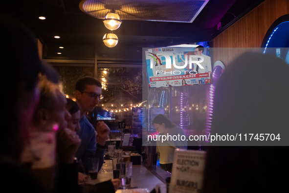 People watch the 2024 election results during a watch party at the Admiral in Washington, DC, on November 5, 2024.  Voters are choosing the...