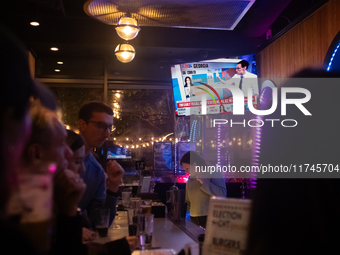 People watch the 2024 election results during a watch party at the Admiral in Washington, DC, on November 5, 2024.  Voters are choosing the...