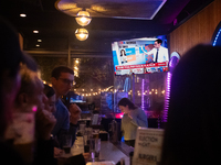 People watch the 2024 election results during a watch party at the Admiral in Washington, DC, on November 5, 2024.  Voters are choosing the...