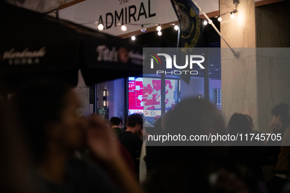 People watch the 2024 election results during a watch party at the Admiral in Washington, DC, on November 5, 2024.  Voters are choosing the...