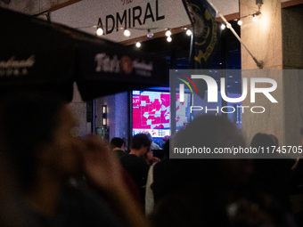 People watch the 2024 election results during a watch party at the Admiral in Washington, DC, on November 5, 2024.  Voters are choosing the...