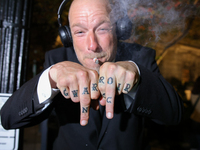 A man displays tattoos while smoking marijuana near the White House in Washington, D.C. on November 5, 2024. (