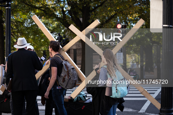 People carry large crosses to the White House on Election Day in Washington, DC, on November 5, 2024.  Americans determine whether Vice Pres...