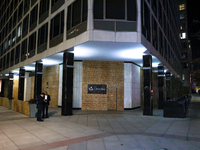 People stand near boarded up buildings near the White House in Washington, D.C. on November 5, 2024 as results are tallied for the president...