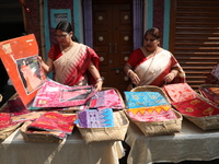 A woman arranges free religious materials to distribute to devotees who will perform prayers ahead of the Hindu religious festival of Chhat...