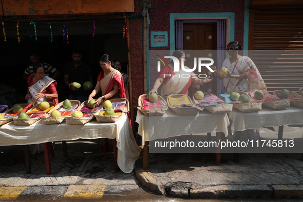 A woman arranges free religious materials to distribute to devotees who will perform prayers ahead of the Hindu religious festival of Chhat...