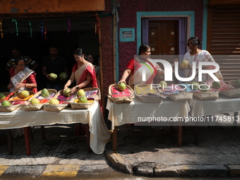 A woman arranges free religious materials to distribute to devotees who will perform prayers ahead of the Hindu religious festival of Chhat...